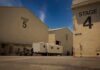 Hollywood Mega-Merger Surges – Prices Next? Film studio stages with numbered buildings and trailer