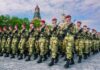 Kremlin Turns Election Into War Ad Soldiers in camouflage uniforms march in formation with rifles