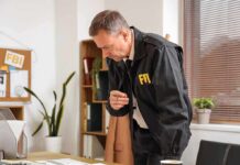 Shocking Exit Rocks FBI Leadership FBI agent reviewing documents at a desk