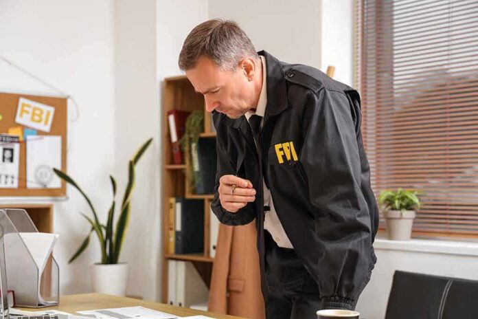 shutterstock_2449658073 FBI agent reviewing documents at a desk