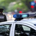 Record Crime Drop Stuns America police car roof with blue emergency lights
