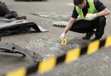 Forensic investigator marking evidence at crash scene
