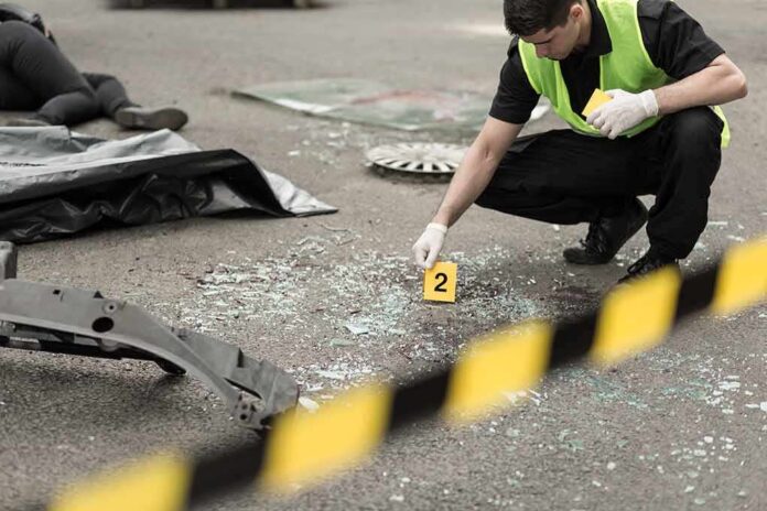 shutterstock_301329224 Forensic investigator marking evidence at crash scene