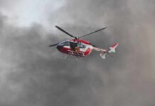 News Chopper Plunges Mid-Coverage Rescue helicopter hovers amid thick smoke