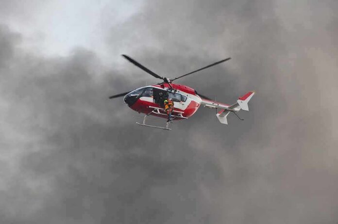 Rescue helicopter hovers amid thick smoke