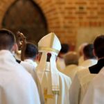 Pope Confronts 1792 Killing Ground Bishop in white mitre among clergy during church procession