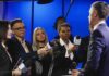 Access War Erupts – 14 Days Ticking Journalists interview a man in a suit with microphones