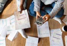 Heating-Oil Spike: 31% Budget Punch People sitting on floor calculating bills with a calculator