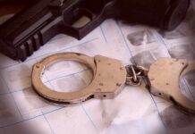 Marijuana Empire – Run From The Statehouse By A Grandma? Handcuffs on fingerprint sheets beside a handgun