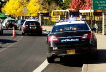 Gunfire Erupts At Homecoming – No Arrests Police cars with flashing lights near school buses on a city street