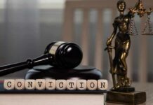 Judge's gavel and Lady Justice statue on desk