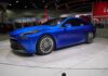 SpaceX Thrusters Flip Tesla Mid-Air Blue sedan on display at an auto show