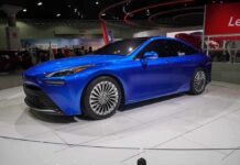 SpaceX Thrusters Flip Tesla Mid-Air Blue sedan on display at an auto show