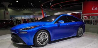 Blue sedan on display at an auto show
