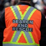 Week In The Wild – Grandma Found Alive Search and rescue worker in orange reflective vest