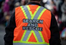 Search and rescue worker in orange reflective vest