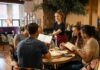 Server taking orders from a group at a restaurant table