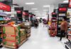 Retailers Chase A TRILLION-Dollar December Interior of a grocery store with shelves filled with products and shoppers