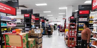 Interior of a grocery store with shelves filled with products and shoppers