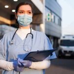 Plague Lab Panic Deepens – Records Missing? Healthcare worker in scrubs wearing mask and gloves holding a clipboard