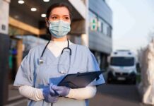 Plague Lab Panic Deepens – Records Missing? Healthcare worker in scrubs wearing mask and gloves holding a clipboard