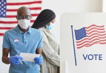 Blue Wave Warning: House Teeters Voters wearing masks at a polling station