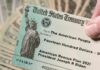 Trump-Branded $500 Checks Flood Swing States United States Treasury check held over a stack of cash