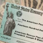 Trump-Branded $500 Checks Flood Swing States United States Treasury check held over a stack of cash