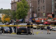 Homecoming Turns To Mayhem Police investigate a taped-off urban street crime scene
