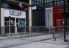 Police station entrance with barriers and French flag colors