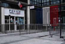 Principal Down – Staffer Stops 14 Year Old Shooter Police station entrance with barriers and French flag colors