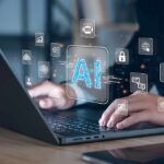 AI Windfall: Bezos Dangles Three-Day Weeks Hands typing on laptop with AI and tech icons overlay