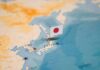 Marine Indictment Ignites Base Backlash Japanese flag pin marking Japan on a world map