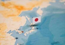 Marine Indictment Ignites Base Backlash Japanese flag pin marking Japan on a world map