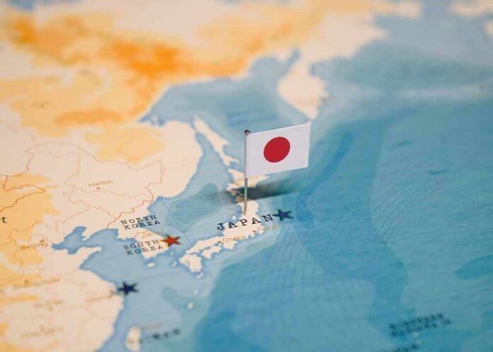 Japanese flag pin marking Japan on a world map