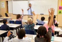 Oregon Horror: Did Mom Buy The Gun? Teacher at front of classroom as students raise hands